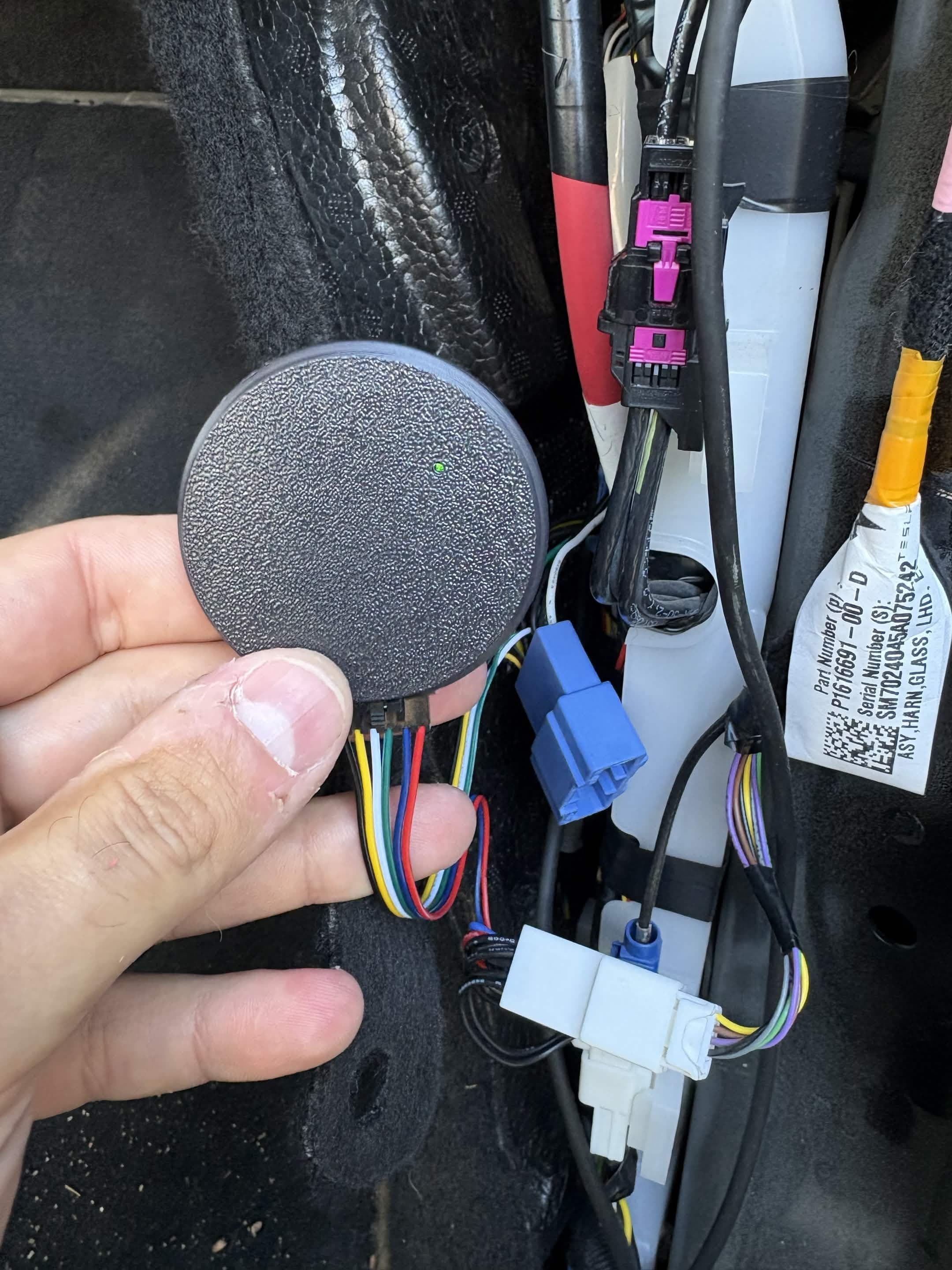DashKit connected to a car's wiring harness behind the trim